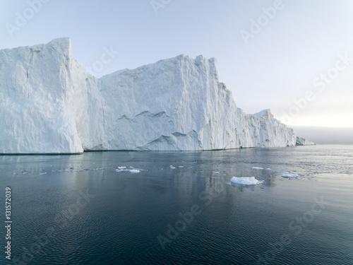 Arctic Icebergs Greenland in the arctic sea. You can easily see that iceberg is over the water surface, and below the water surface. Sometimes unbelievable that 90% of an iceberg is under water © murattellioglu