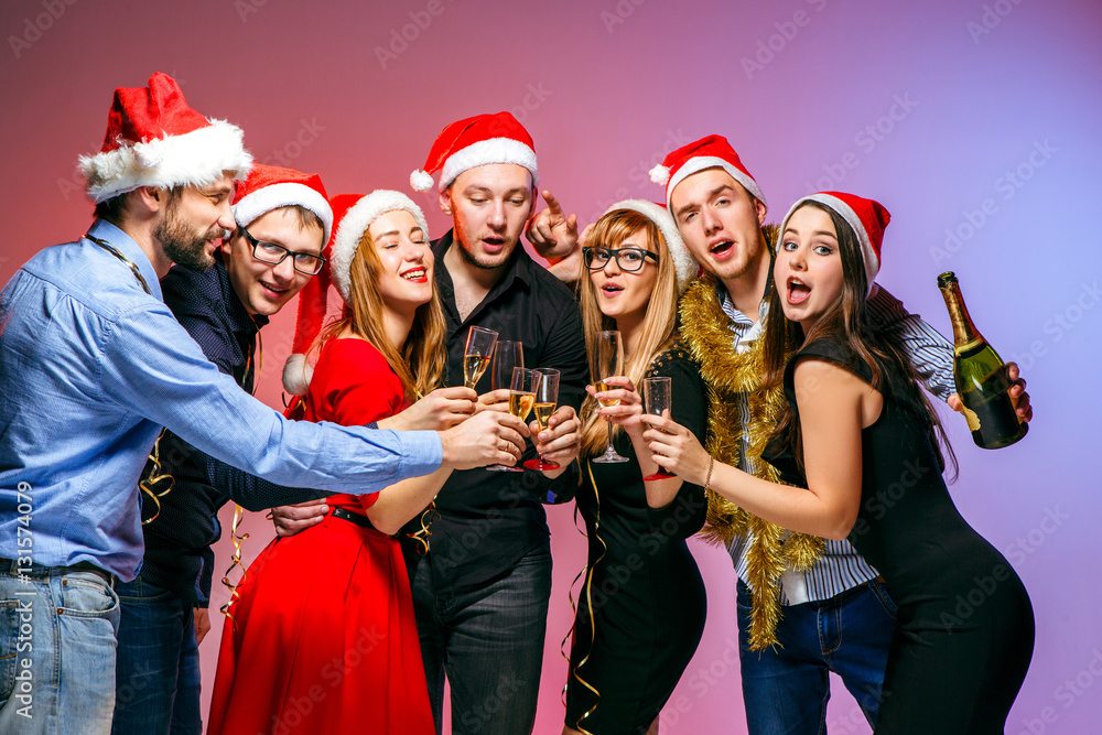 Many young women and men drinking at christmas party