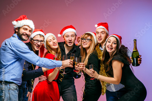 Many young women and men drinking at christmas party