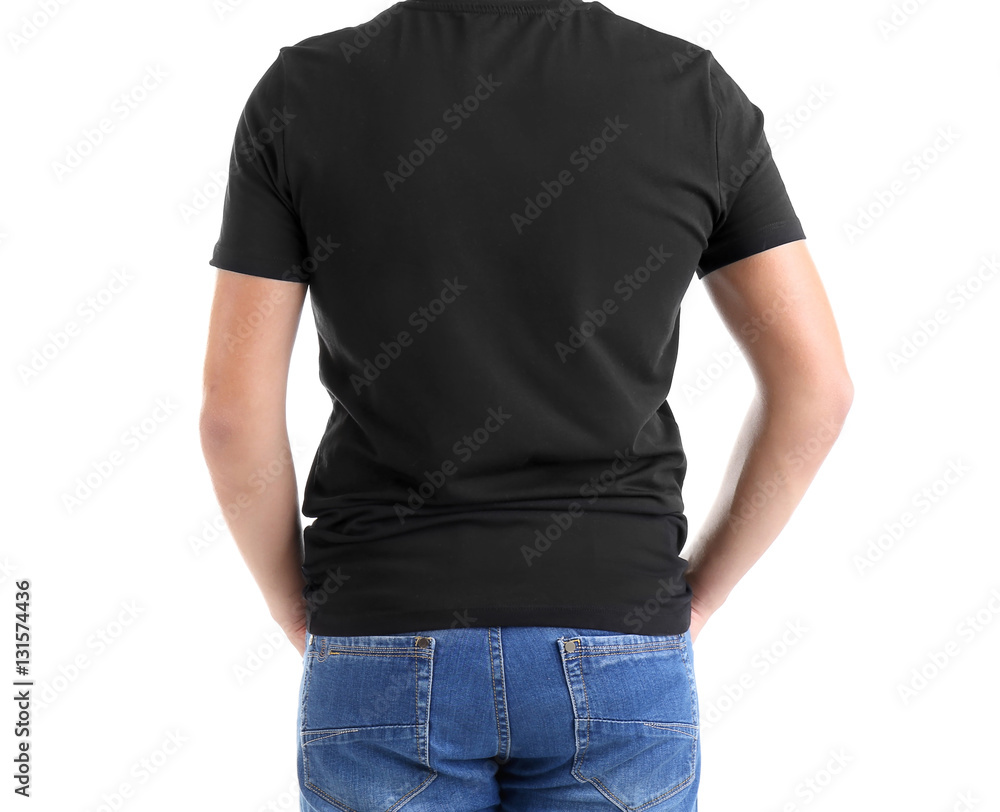 Obraz premium Young man's back view in blank black t-shirt and blue jeans, casual apparel mockup for design and branding