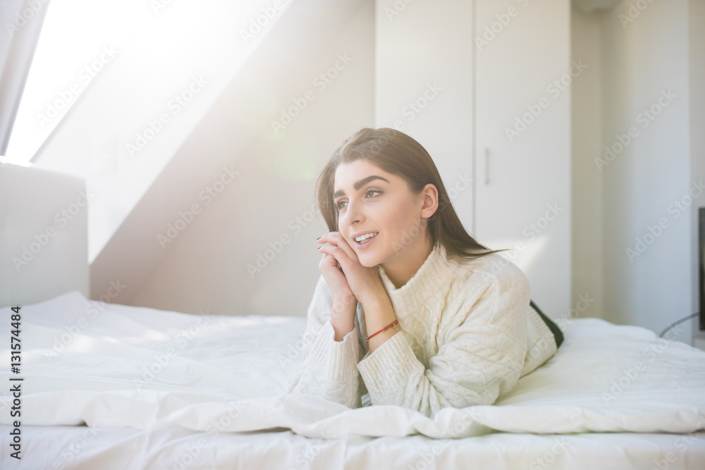 Happy woman lying on the bed and waking up in the morning Happy woman lying on the bed and waking up in the morning