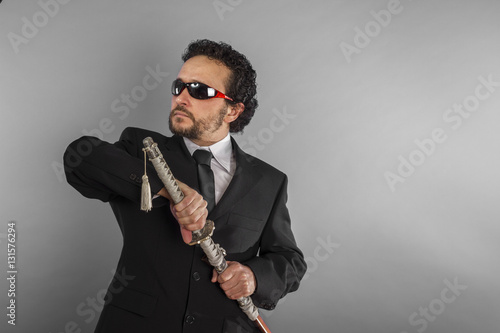 Dark businessman, aggressive lawyer with Japanese sword, defiant