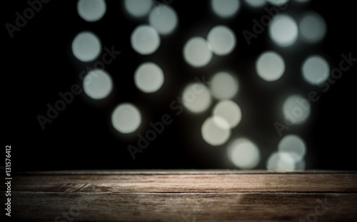 brown wooden texture in the background, glowing lights on the dark