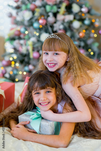 Two adorable girls with Christmas gifts