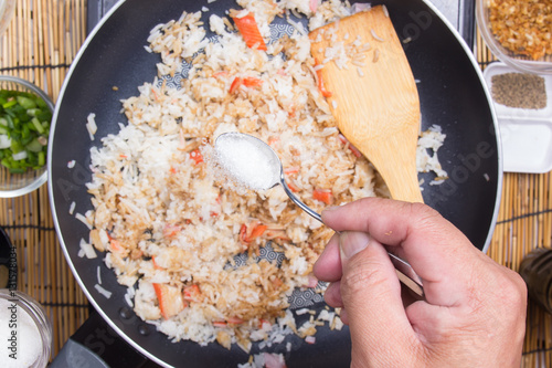 Chef putting sugar for cooking rice photo