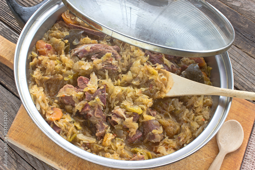 Sauerkraut with smoked pork meat in pot Sauerkraut with smoked pork meat in pot