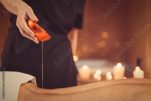 Fotografie Skillful beautician preparing client for massage