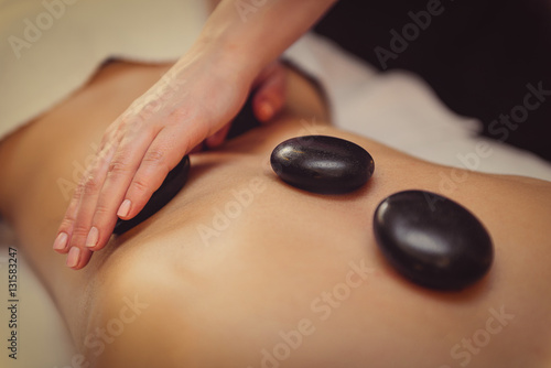 Skillful beautician undergoing massage for woman