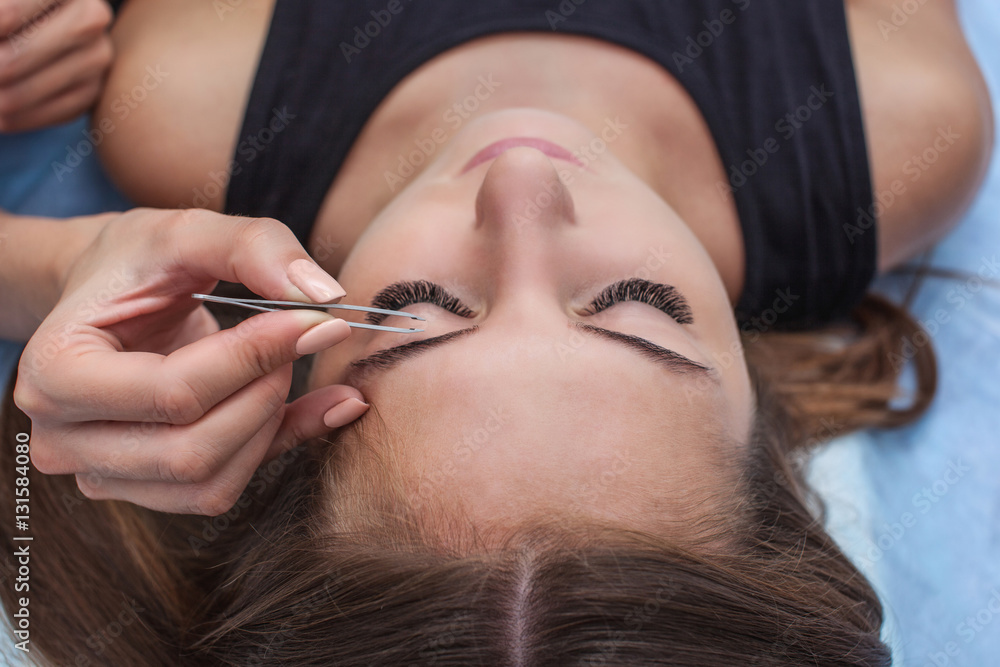 Master makeup corrects and gives shape to pull out with forceps previously painted with henna eyebrows in a beauty salon. Professional care for face. Master makeup corrects and gives shape to pull out with forceps previously painted with henna eyebrows in a beauty salon. Professional care for face.