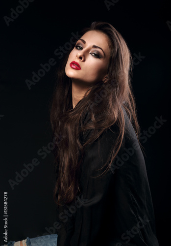 Sexy female model with long brown hair posing in black shirt on