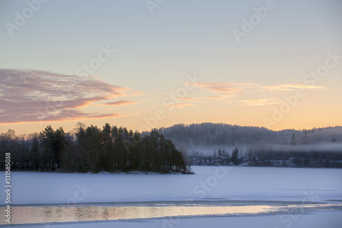 Sunrise on a winter morning. Sky is turning orange and yellow.