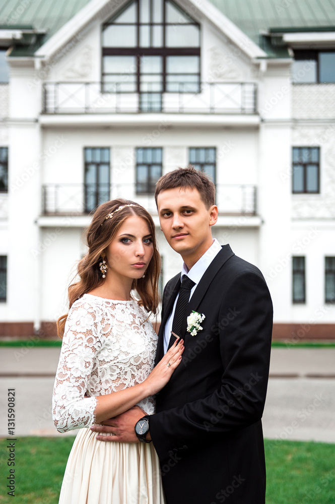 gorgeous happy wedding couple walking and kissing in the old city of Minsk, Belarus gorgeous happy wedding couple walking and kissing in the old city of Minsk, Belarus