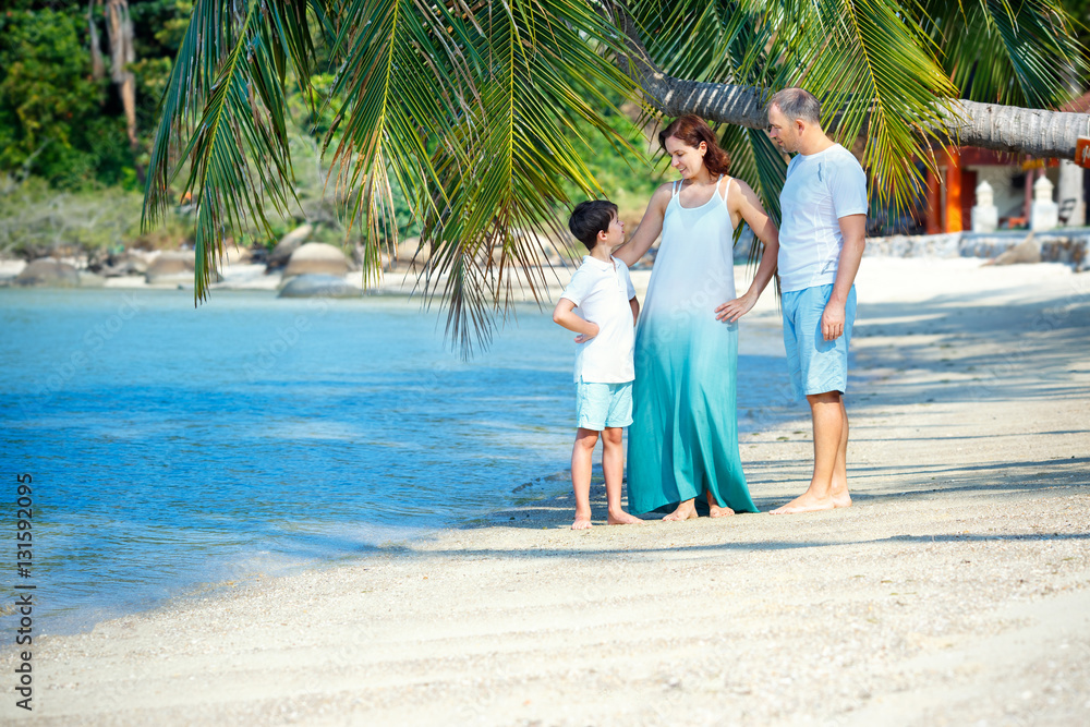 Young family of three having fun tropical beach, Thailand, Asia Young family of three having fun tropical beach, Thailand, Asia
