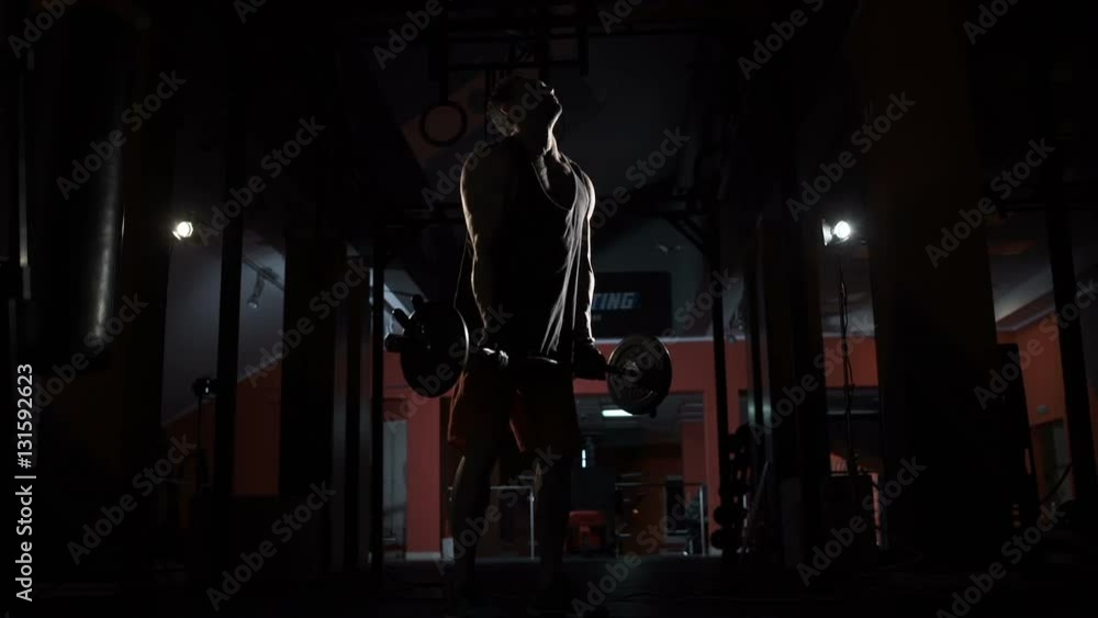The athlete is lifting a weight The athlete is lifting a weight