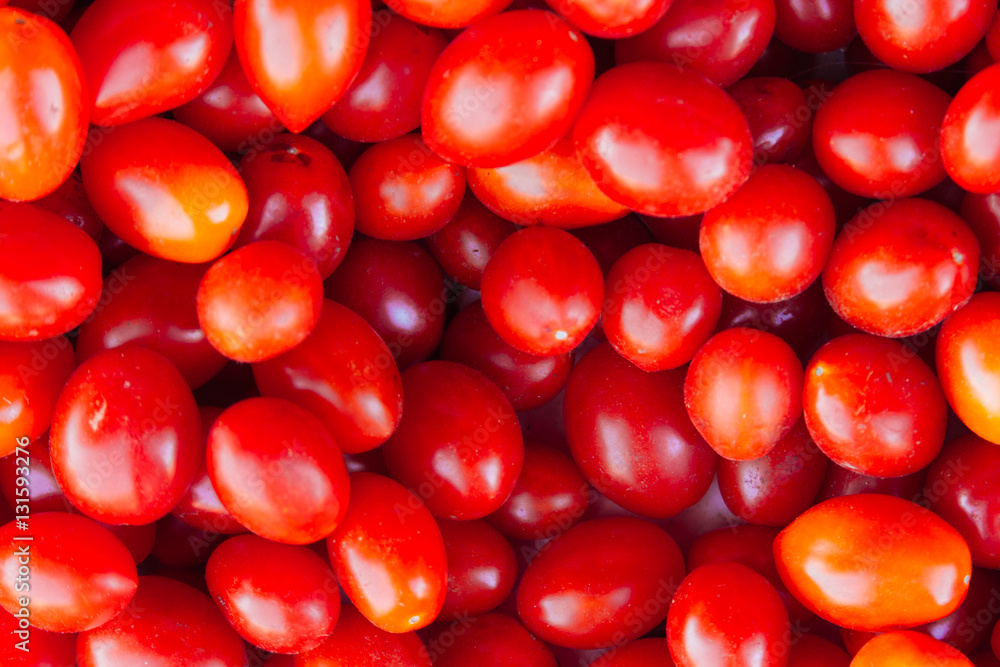 Close-up of a bunch of red cherry tomatoes in a greengrocer's sh Close-up of a bunch of red cherry tomatoes in a greengrocer's sh