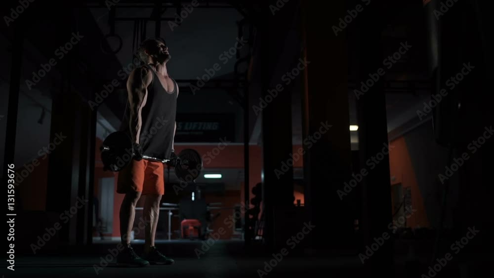 Muscled lifts a heavy barbell Muscled lifts a heavy barbell