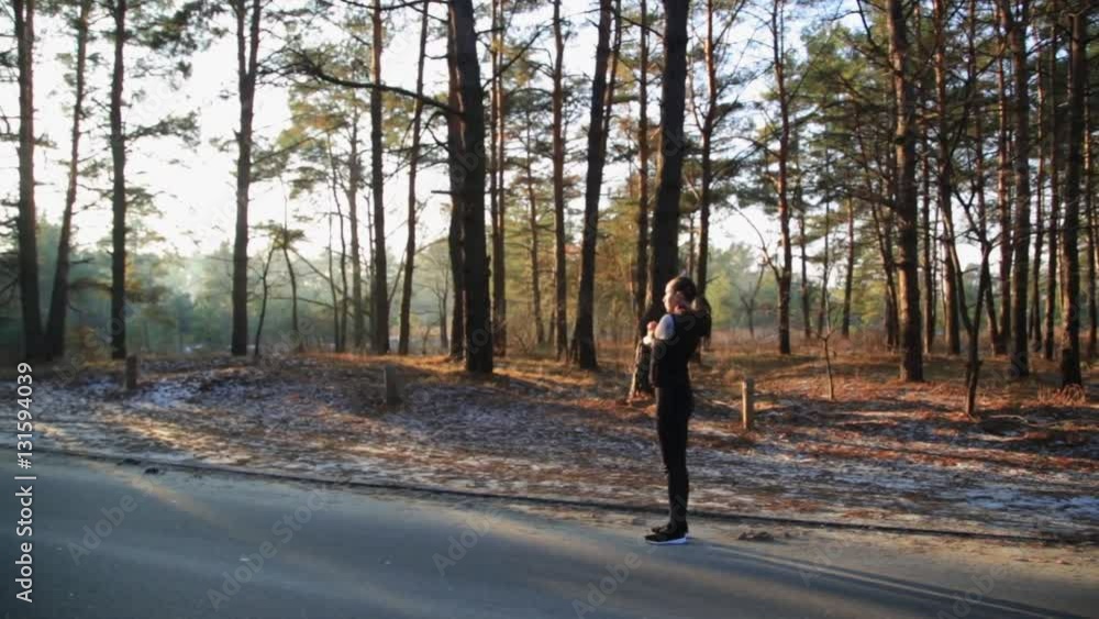 Athletic middle aged woman stretching in the green leaved woods on a dirt road before a run. Healthy life style concept. Athletic middle aged woman stretching in the green leaved woods on a dirt road before a run. Healthy life style concept.