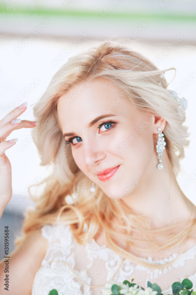 Beautiful bride. Wedding hairstyle and make up.Young bride in wedding dress holding bouquet Beautiful bride. Wedding hairstyle and make up.Young bride in wedding dress holding bouquet