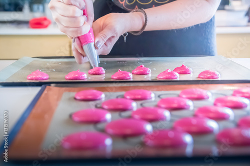 baker is making homemade macarons