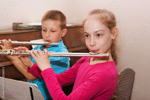 a boy and a girl playing the flute