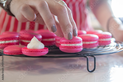 baker is making homemade macarons