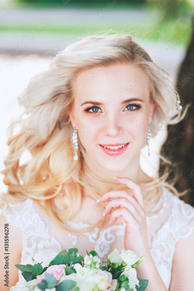 Beautiful bride. Wedding hairstyle and make up.Young bride in wedding dress holding bouquet Beautiful bride. Wedding hairstyle and make up.Young bride in wedding dress holding bouquet