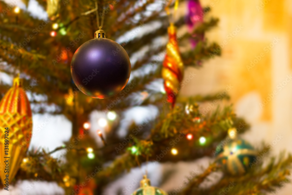 Christmas ball hanging on fir tree branch