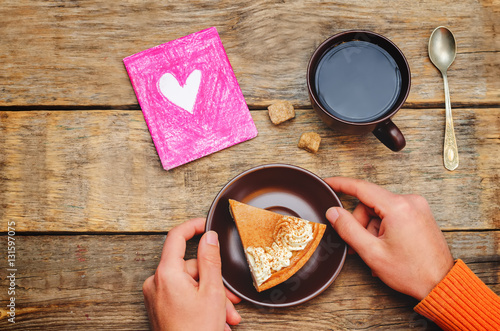 Men's hands hold a plate with cake for Valentine's Day