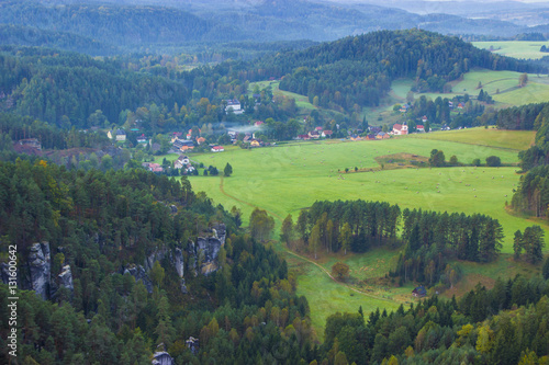 Hills and villages with foggy morning. Morning fall valley of Bohemian Switzerland park.   