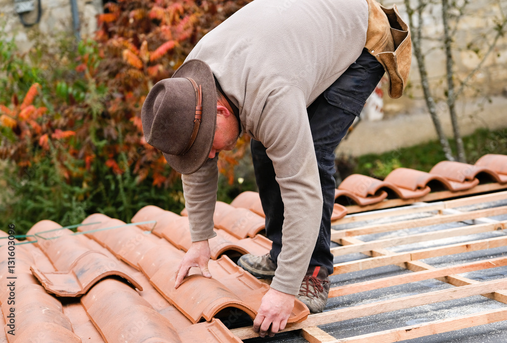 Construction Worker On A Renovation Roof Covering It With Tiles Stock Photo Adobe Stock