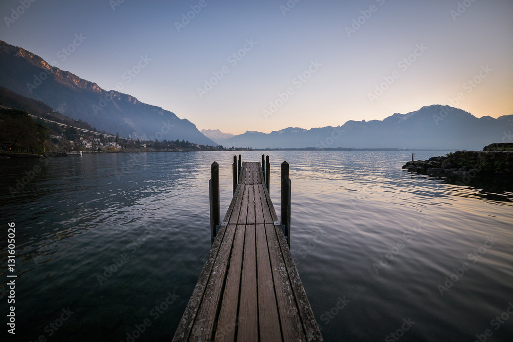 Perspective view of a wooden pier on the pond at sunset, Switzerland