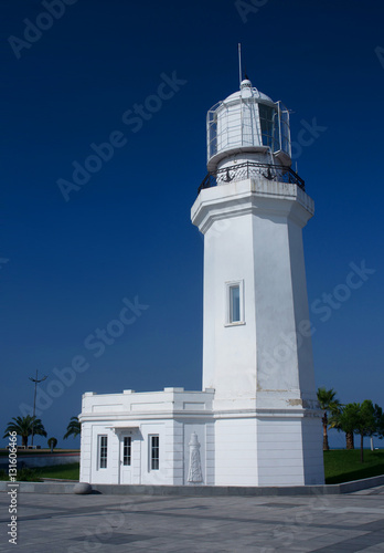Old white lighthouse located at city seafront of Batumi, Adhara, photo