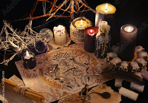 Mystic still life with demon drawing and black candles