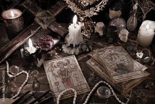Mystic ritual with tarot cards, magic objects and candles in grunge style