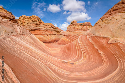 Full view of The Wave - a dramatic erosional sandstone rock formation located in North Coyote Buttes area of Paria Canyon-Vermilion Cliffs Wilderness, at Arizona-Utah border.
