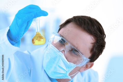 Young male scientist making...