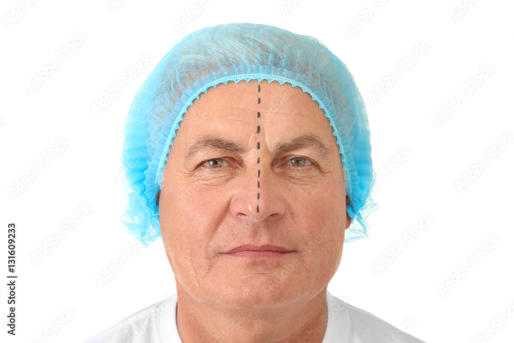 Handsome senior man with marks in medical hat on white background Handsome senior man with marks in medical hat on white background