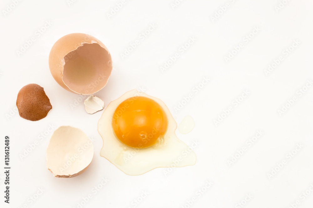 Raw egg cracked on white background Raw egg cracked on white background