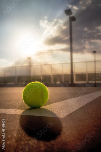 Tennis ball on hard court at sunset © icedmocha