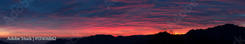 Fiery sunset from mountain pick in a cloudy evening. Fall season. Orobie mountains. Italian Alps.Fiery sunset from mountain pick in a cloudy evening. Fall season. Orobie mountains. Italian Alps.