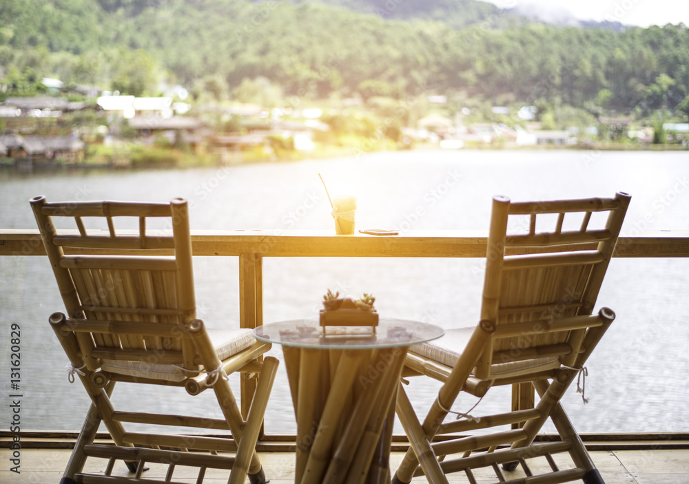 Fototapeta premium Relaxing wooden desk on wood terrace against beautiful view