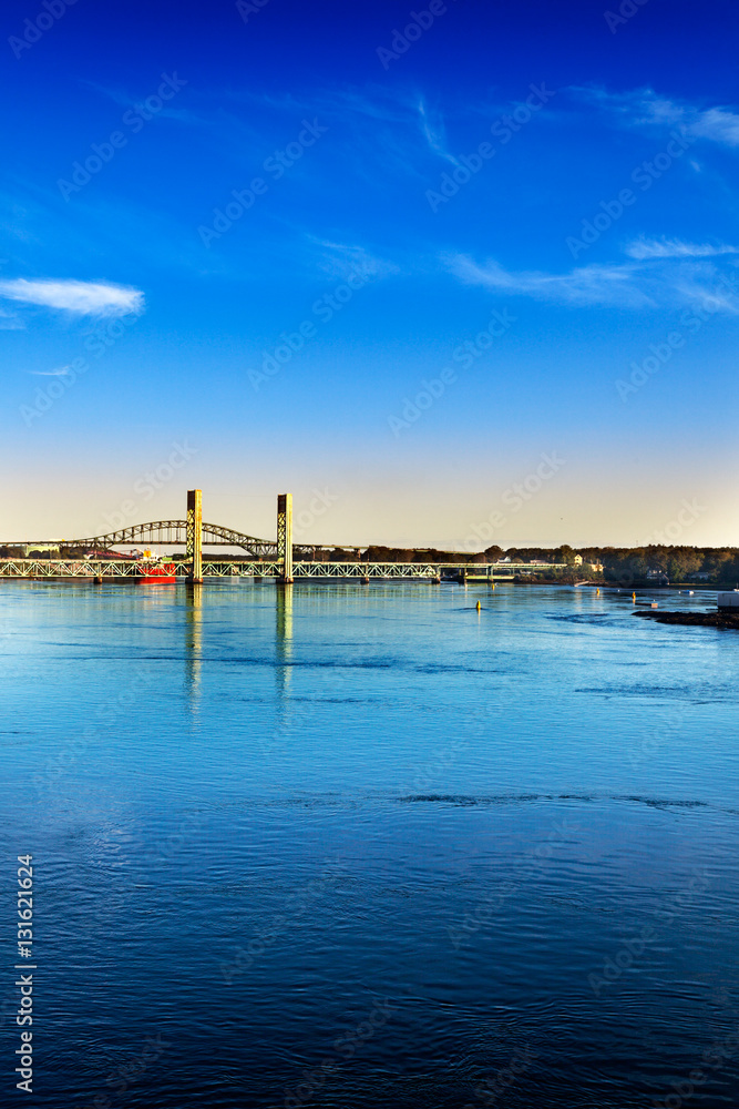 Morning sun hits the fast moving Piscataqua River and Sarah M. Long Bridges, connecting Portsmouth, New Hampshire and Maine Morning sun hits the fast moving Piscataqua River and Sarah M. Long Bridges, connecting Portsmouth, New Hampshire and Maine