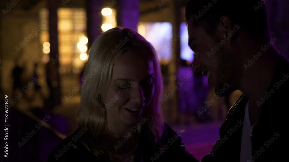Couple in love standing near night club and talking, first date, relationship Couple in love standing near night club and talking, first date, relationship
