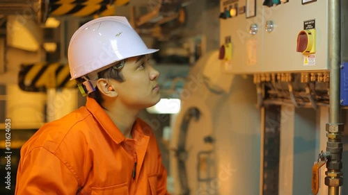 Asian engineer in white helmet.