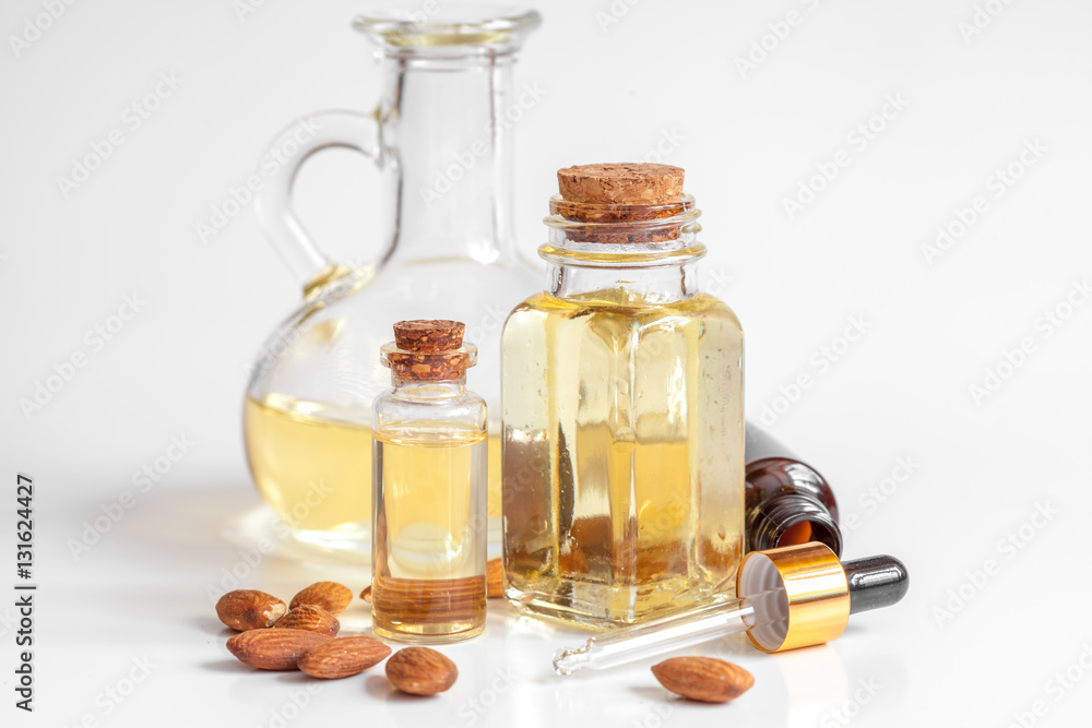 cosmetic almond oil in glass bottle on white background cosmetic almond oil in glass bottle on white background