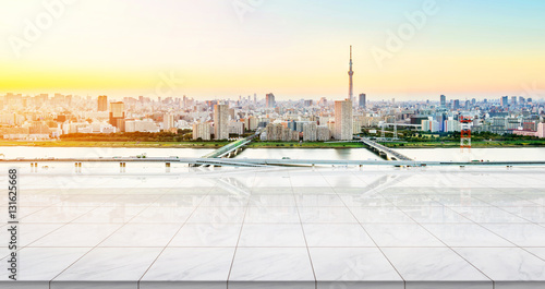 Business concept - Empty marble floor top with panoramic modern cityscape building bird eye aerial view under sunrise and morning blue bright sky of Tokyo skytree, Japan for display or montage product