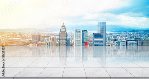 Business concept - Empty marble floor top with panoramic modern cityscape building bird eye aerial view under sunrise and morning blue bright sky of Taipei, Taiwan for display or montage product