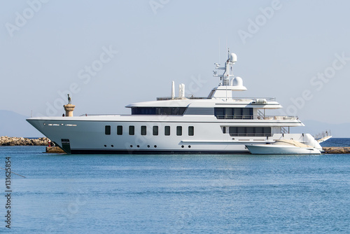 The large modern white private yacht alongside the dock. © vladimircaribb