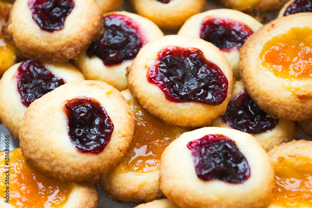 Homemade cookies filled with jelly jam on a baking paper. Homemade cookies filled with jelly jam on a baking paper.