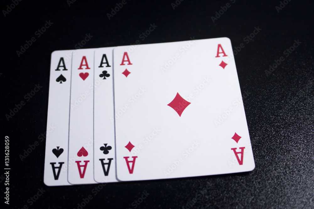 Obraz premium ace four of a kind poker card on dark black background